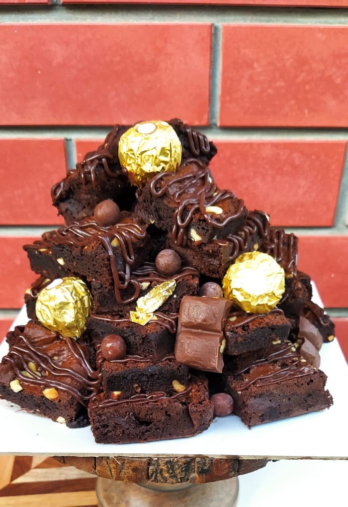 Stacked brownie tower topped with Ferrero Rocher and chocolate pearls