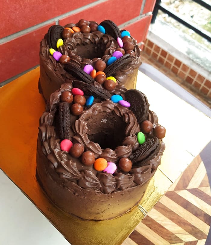 Number-shaped birthday cake covered in chocolate frosting, Oreos and candies